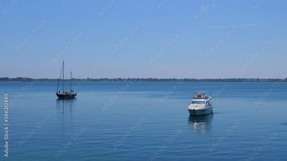 Two yachts anchored in the calm blue sea bay by Italian coast. Two yachts anchored in the calm blue sea bay by Italian coast.