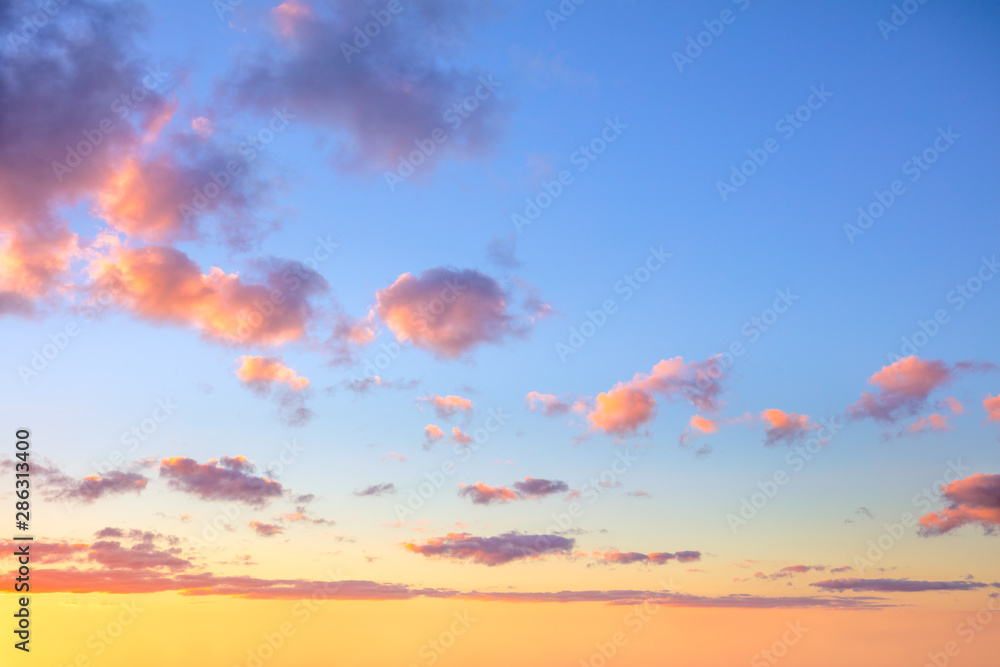 Gentle colors of sunrise sundown sky with colorful small clouds