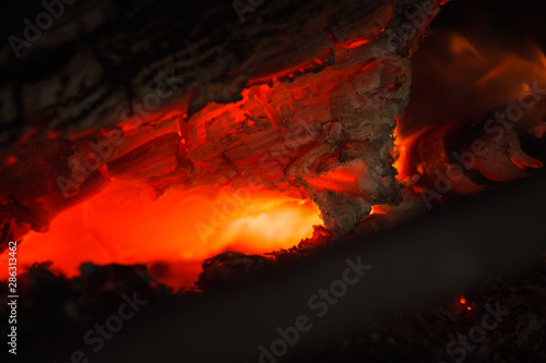 Burning coal closeup. Abstract background red hot burning fire in the oven macro close up of coal. Shallow depth of field (DOF)
