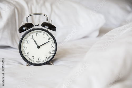 Retro alarm clock on the bed