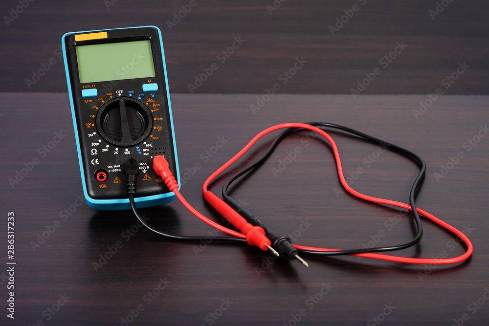 Digital multimeter with probes on a white background. Digital multimeter with probes on a white background.