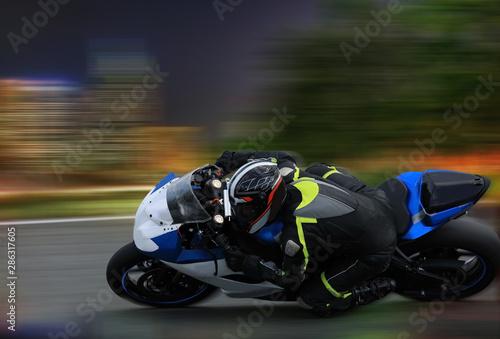 Racing bike rider leaning into a fast corner at high speed with motion blur © Alexey Kuznetsov