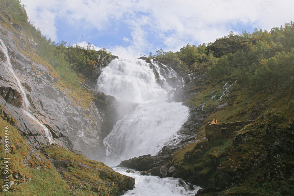 The grand waterfall of Kjosfossen in summer daytime. One of the largest in Norway