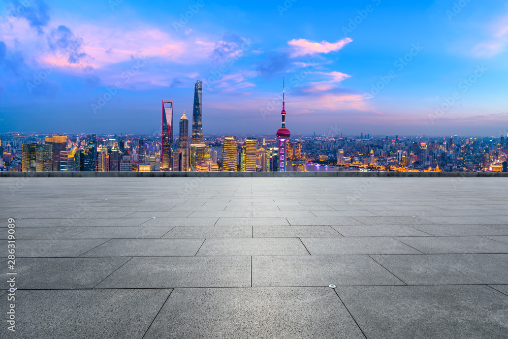 Empty square floor and city skyline with buildings at night in Shanghai,China.