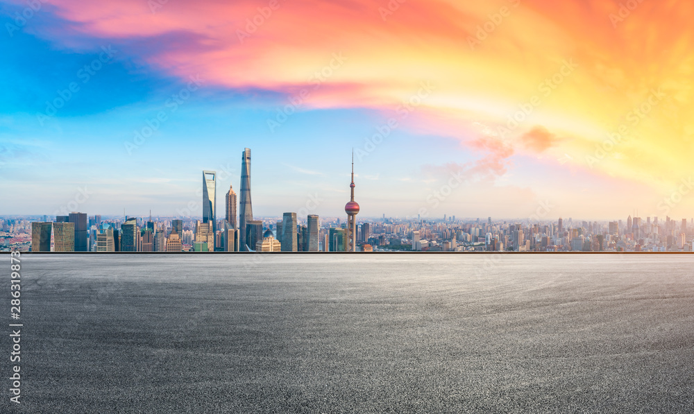 Obraz premium Shanghai skyline and modern buildings with empty race track at sunset,China.