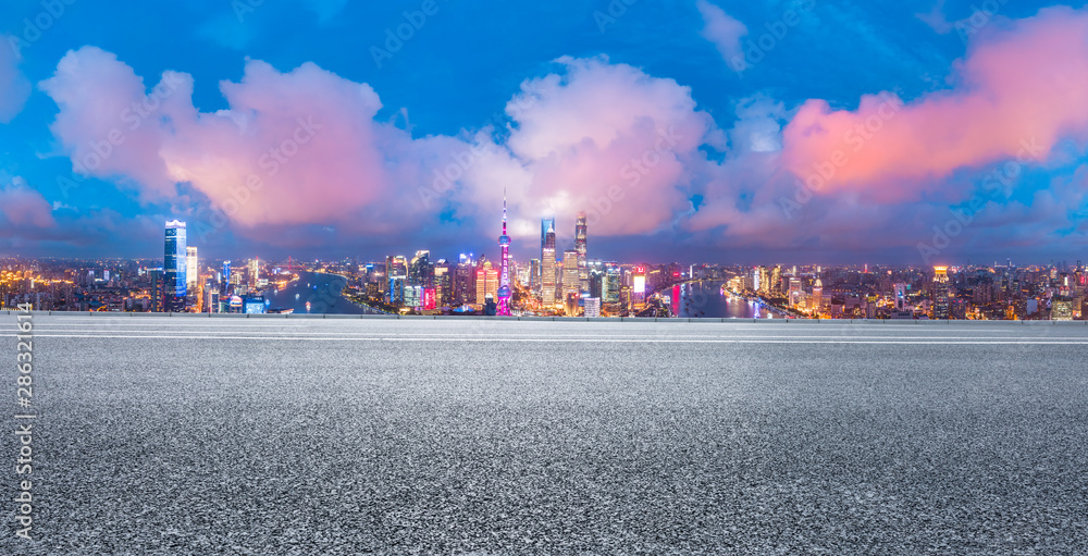 Empty highway and modern city skyline at night in Shanghai,China.