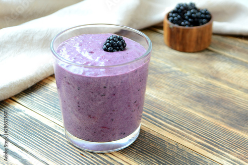 Delicious smoothie with organic blackberries in a transparent glass Healthy eating concept