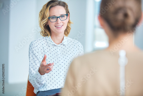 Businesswoman brainstorming colleagues at new office