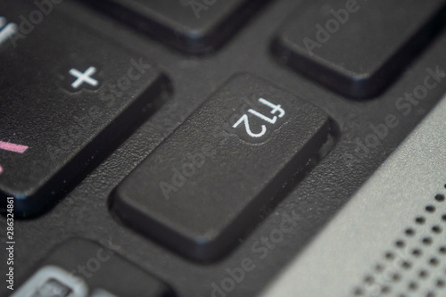 Close up of the f12 key on a keyboard