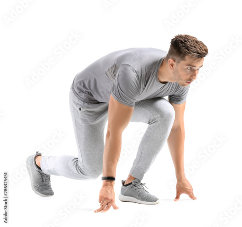 Photography Sporty young man in crouch start position on white background