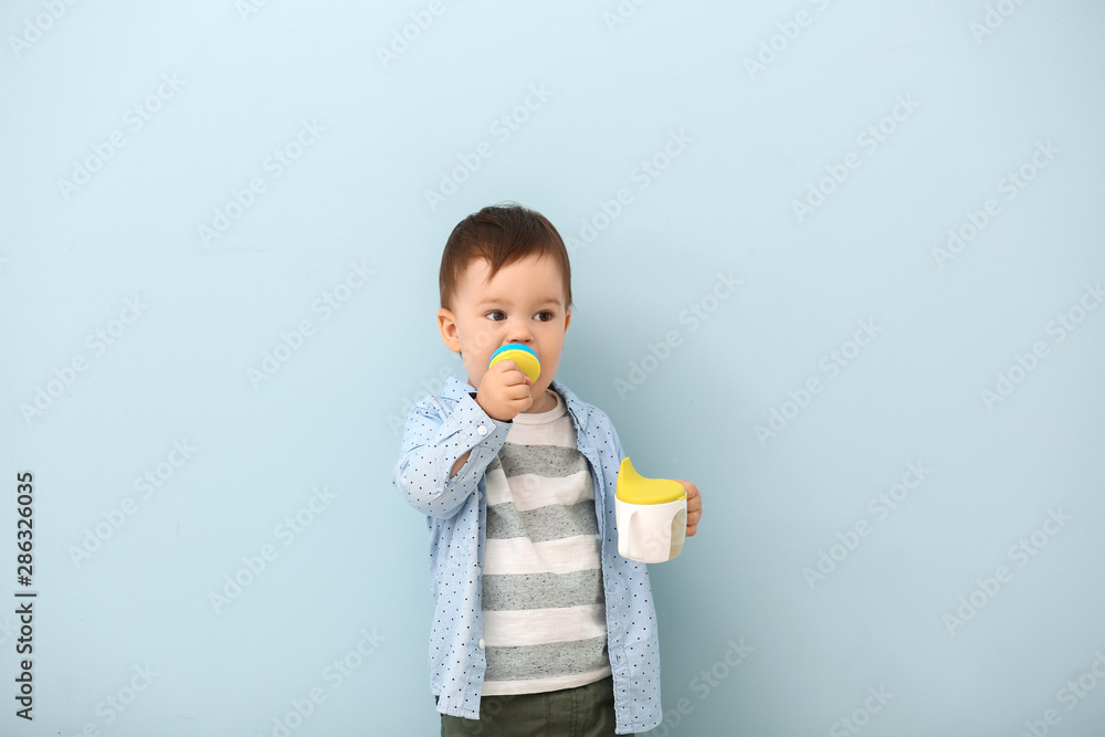 Cute little boy with nibbler on color background Cute little boy with nibbler on color background