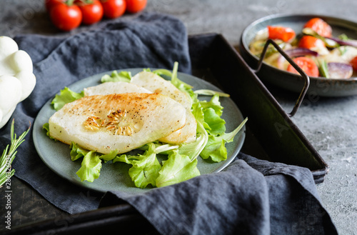 Fried white patty pan squash slices with vegetable garnish photo