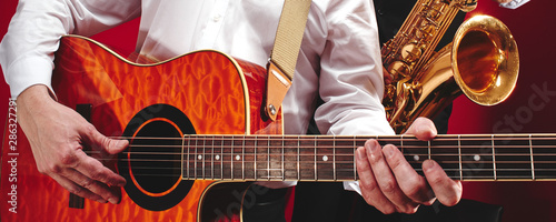Photography Group of two musicians, male jazz band, guitarist and saxophonist in classical c