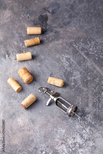 Exquisite vintage corkscrew for wine on a textural background. Copy space. Place for your text.