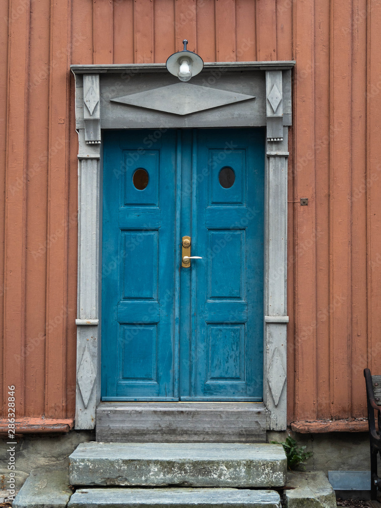 Old blue wooden vintage door with stone porch