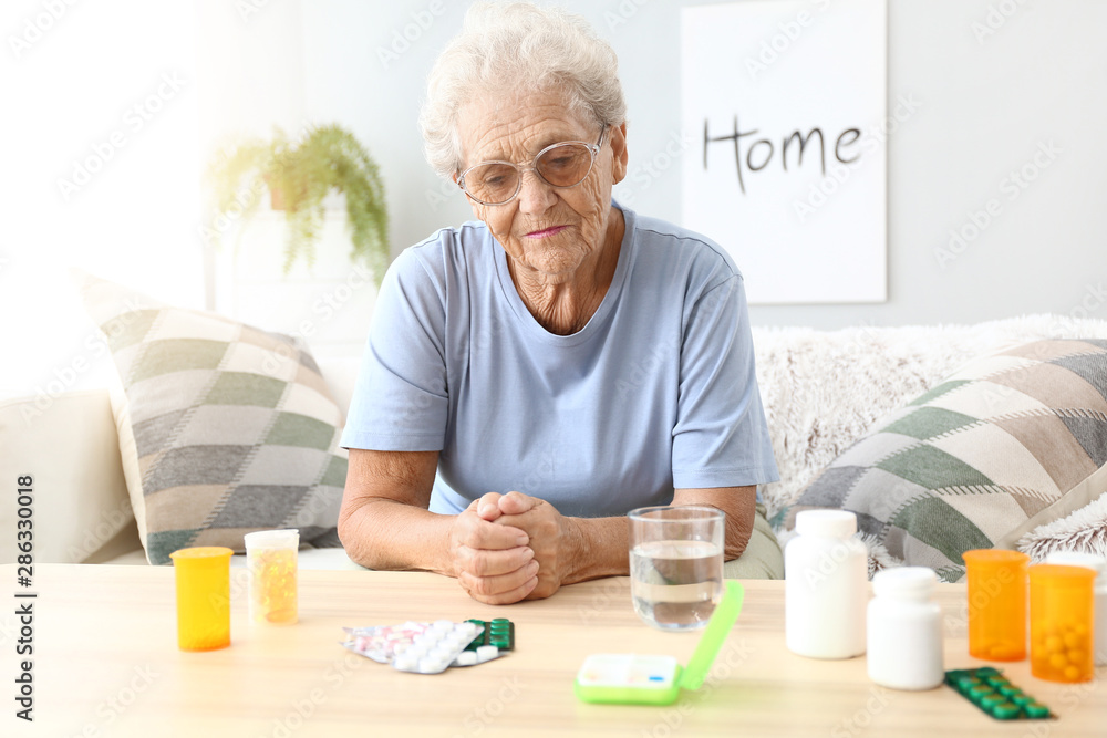 Elderly woman with medicines at home Elderly woman with medicines at home