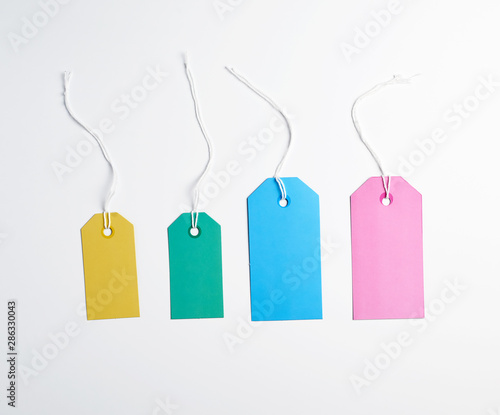 colored paper tags on a white rope, white background