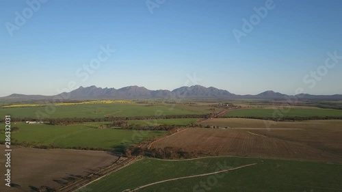 Wallpaper Mural Aerial panoramic view of the scenic mountains of the Stirling Range National Park in Western Australia, flying above a wide open plain of agricultural fields on a sunny day with blue sky. Torontodigital.ca