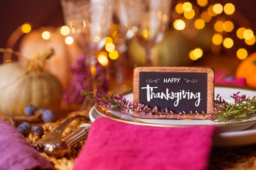 Autumn place setting  -  Beautiful decorated table  -  Chalk board with message HAPPY THANKSGIVING