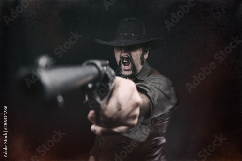An angry cowboy aiming a revolver pistol and yelling.