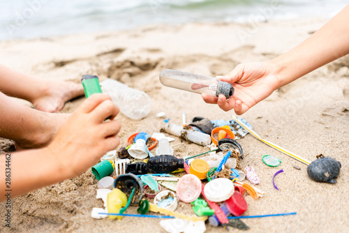 Children Sorting Through Plastic Waste on a Beach photo