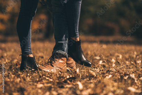 Careless couple in jeans in the wood