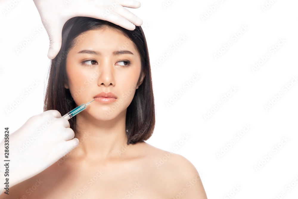 Asain young woman gets injection of botox in her lips. Woman in beauty salon. plastic surgery clinic.Beautiful woman gets botox injection in her face. Asain young woman gets injection of botox in her lips. Woman in beauty salon. plastic surgery clinic.Beautiful woman gets botox injection in her face.