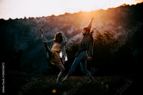 Two people dancing in contemporary stile of ballet at mountain peak