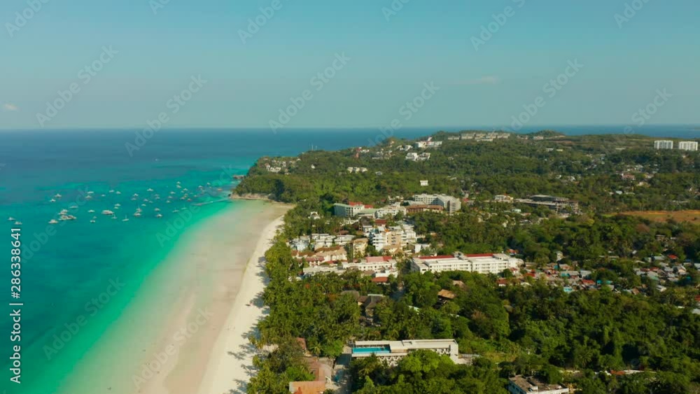 Tropical white sand beach, hotels near the blue lagoon and corall reef. aerial view, Boracay, Philippines. Seascape with beach on tropical island. Summer and travel vacation concept. Tropical white sand beach, hotels near the blue lagoon and corall reef. aerial view, Boracay, Philippines. Seascape with beach on tropical island. Summer and travel vacation concept.