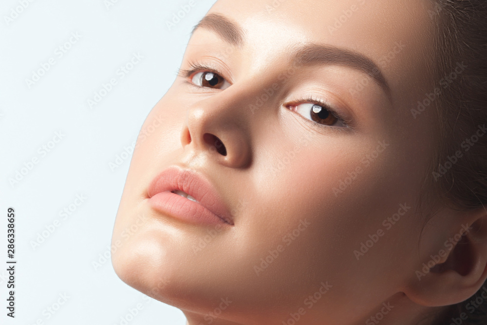 Young beautiful woman with clean perfect skin close-up