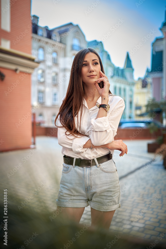 portrait of a beautiful brunette in the city