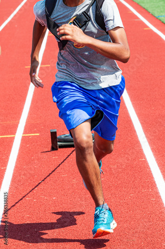 Front view of male athlete running pulling a weighted sled © coachwood