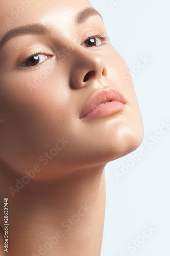 Young beautiful woman with clean perfect skin close-up