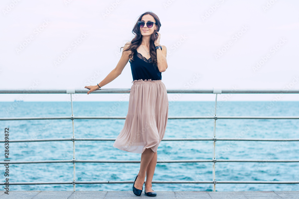 Beautiful young woman in sunglasses and dress on luxury cruise liner boat. Cruise ship vacation woman enjoying travel at sea. Free happy woman looking at ocean. Beautiful young woman in sunglasses and dress on luxury cruise liner boat. Cruise ship vacation woman enjoying travel at sea. Free happy woman looking at ocean.