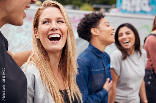 Group Of Female Friends Posing For Selfie On Mobile Phone In Urban Skate Park