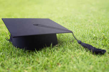 shot of graduation hats on the grass, concept during commencement success graduates of the university,Concept education congratulation. Graduation Ceremony , Leave space for writing descriptive text