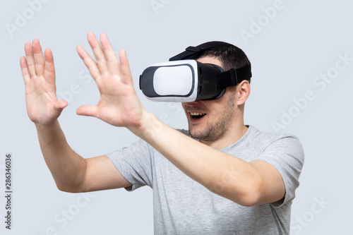 Young man using vr headset, experiencing virtual reality
