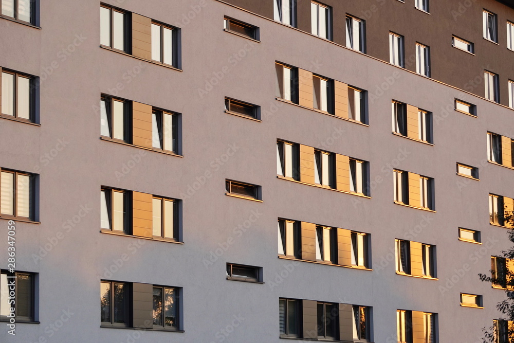 Windows reflecting sunlight at sunset in a modern multi-storey building. Windows reflecting sunlight at sunset in a modern multi-storey building.