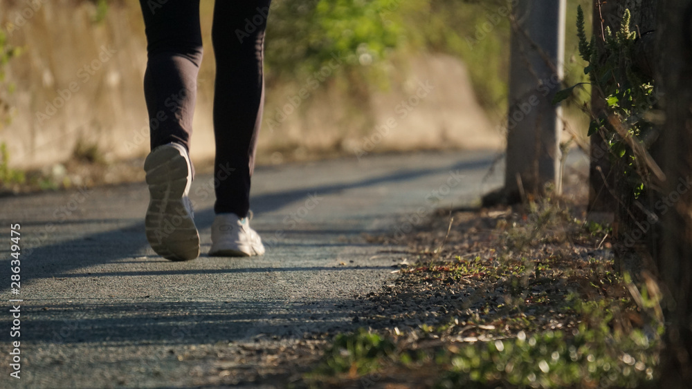 running at the park with a warm morning light, runner on a blurry country background running at the park with a warm morning light, runner on a blurry country background