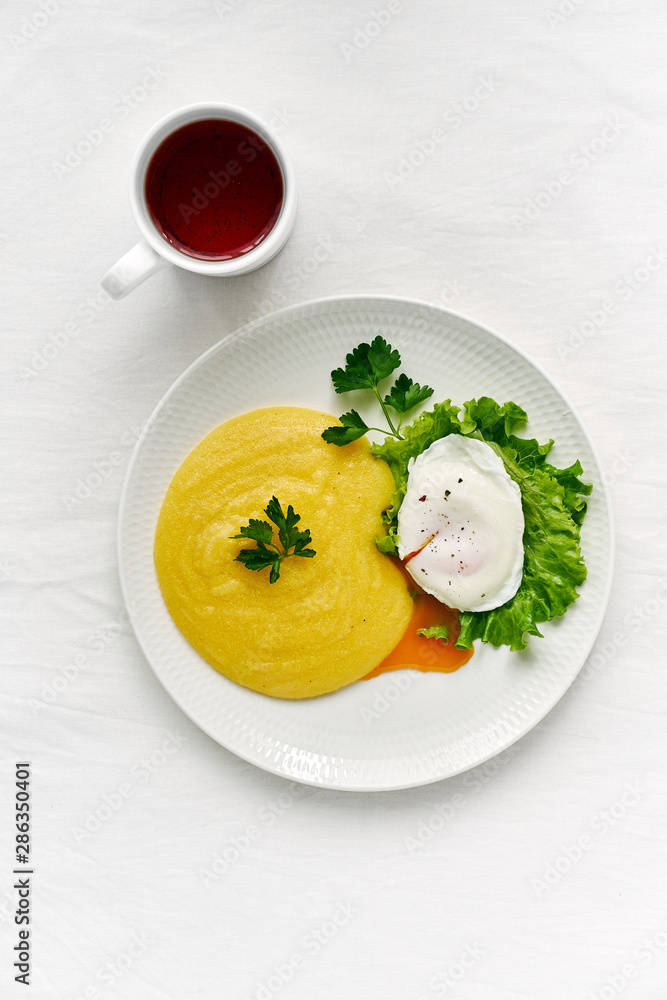 Fodmap diet, poached egg benedict with polenta and parmesan cheese, healthy breakfast Fodmap diet, poached egg benedict with polenta and parmesan cheese, healthy breakfast