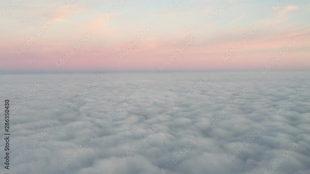 Morning cloudy sunrise with Wing of an airplane. picture for add text message or frame website. Traveling concept. Wing of an airplane flying above the morning clouds Morning cloudy sunrise with Wing of an airplane. picture for add text message or frame website. Traveling concept. Wing of an airplane flying above the morning clouds