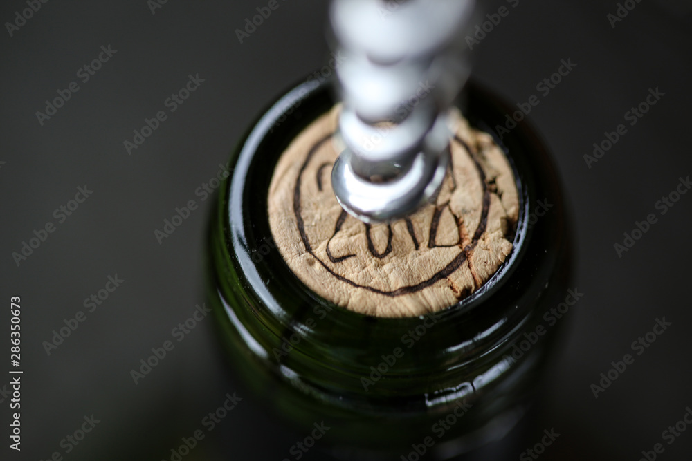 Opening Of Bottle Of Wine With Corkscrew. Close-up Opening Of Bottle Of Wine With Corkscrew. Close-up