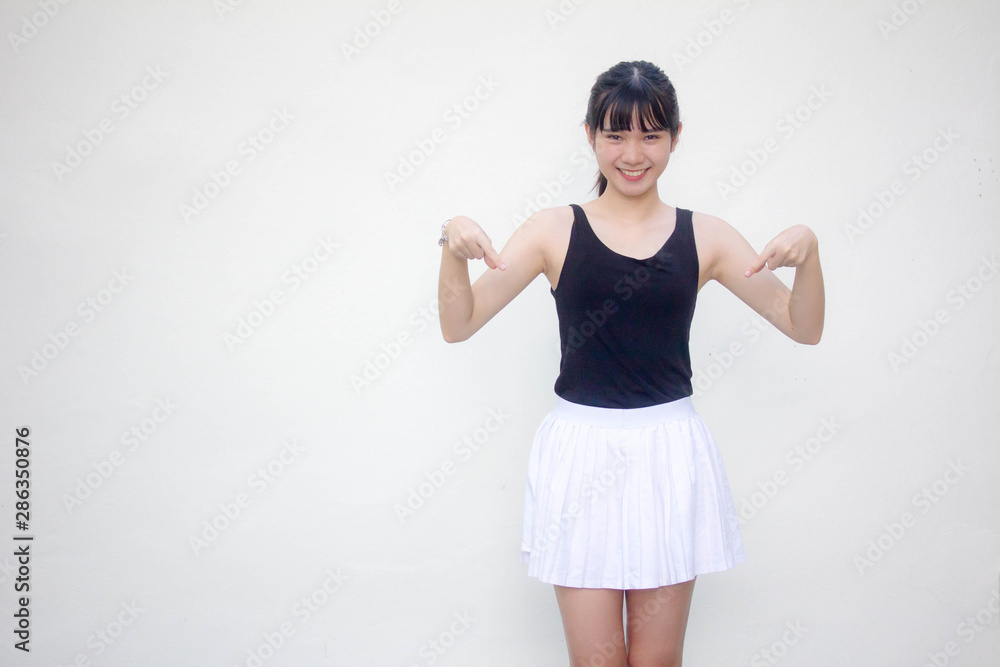 Portrait of thai adult beautiful girl black shirt white skirt pointing Portrait of thai adult beautiful girl black shirt white skirt pointing