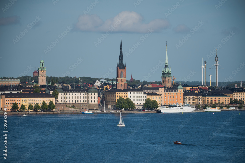 Stockholm buildings at the bay Riddarfjärden between the district Södermalm, Kunsholmen, Gamla Stan and Riddarholmen at sunset with a low sun and fogg torning up in the archipelago Stockholm buildings at the bay Riddarfjärden between the district Södermalm, Kunsholmen, Gamla Stan and Riddarholmen at sunset with a low sun and fogg torning up in the archipelago