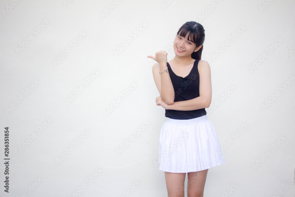 Portrait of thai adult beautiful girl black shirt white skirt pointing Portrait of thai adult beautiful girl black shirt white skirt pointing