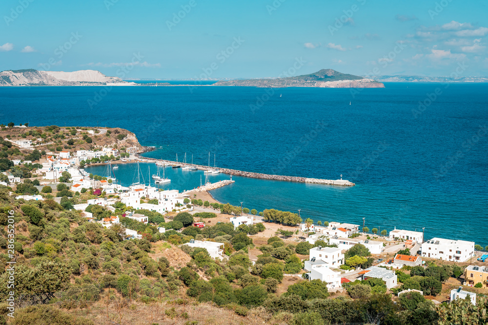 Coastal town in Greece with harbor, view to Aegean Sea, marina with sail boats, Pali, Nisyros Island, Greece