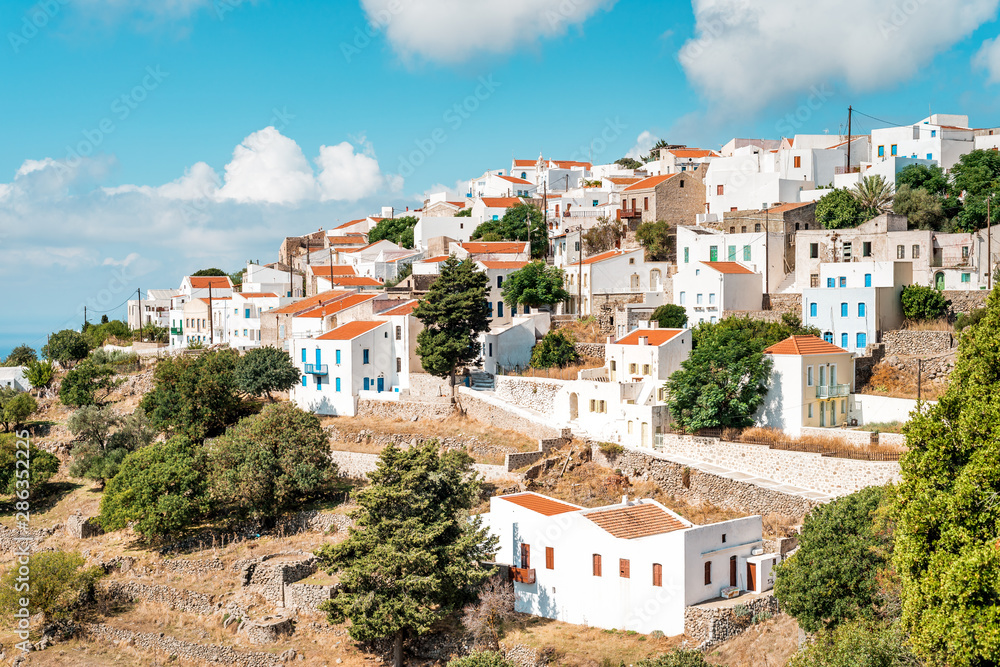 Typical Greek mountain village of Nikia with white houses and red roofs, Nisyros Island, Greece