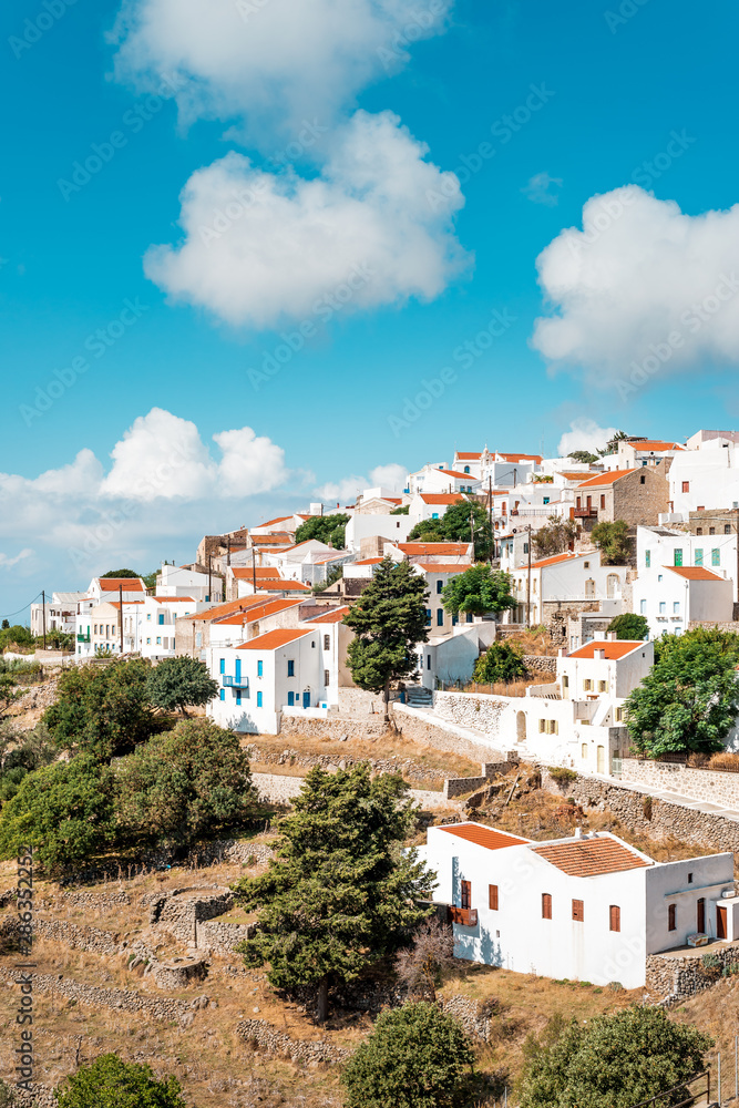 Typical Greek mountain village of Nikia with white houses and red roofs, Nisyros Island, Greece