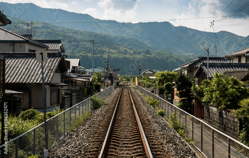train tracks across a japanese village