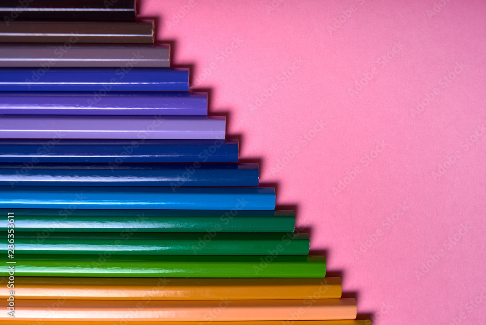Color pencils on pink pastel background, close up. Set of colorful pencils, copy space. Crayons. Top view, flat lay. Back to school, college concept. Abstract background Color pencils on pink pastel background, close up. Set of colorful pencils, copy space. Crayons. Top view, flat lay. Back to school, college concept. Abstract background